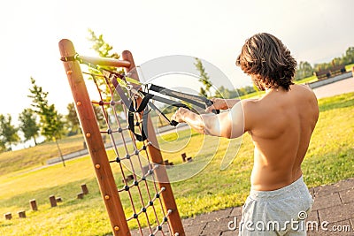 Man exercising biceps curls in the fitness park Stock Photo