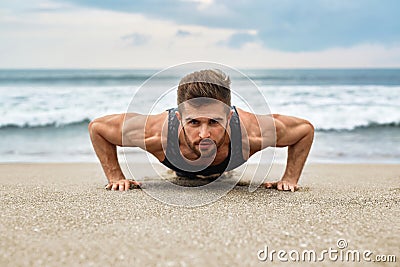 Man Exercising, Doing Push Up Exercises On Beach. Fitness Workout Stock Photo