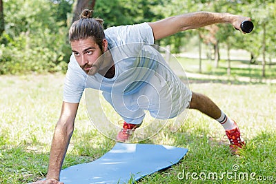 Man exercising midsection core muscles doing side plank exercise Stock Photo