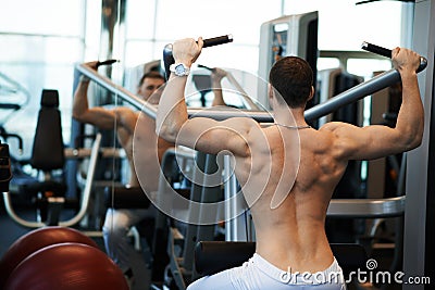 Man exercising on a simulator for dorsi Stock Photo