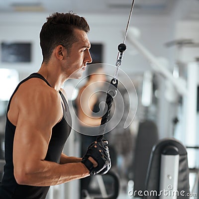 Man exercising in trainer for triceps muscles Stock Photo