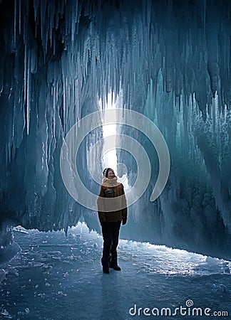 Man exploring ice cave Stock Photo