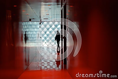 Man Exploring a Minimalist Modern Red Room Interior Stock Photo