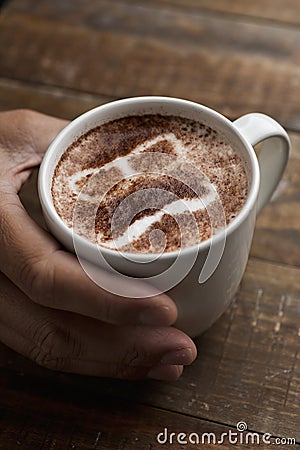 Man face in a cup of cappuccino Stock Photo