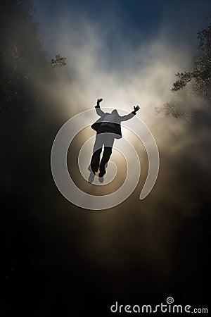 a man falling from the sky. floating in the heavens. flying in the clouds. free man. businessman with his arms raised. Stock Photo