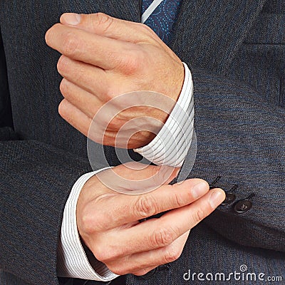 Man fastened the buttons on sleeve business suit closeup Stock Photo