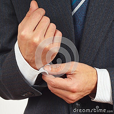 Man fastened the buttons on sleeve suit closeup Stock Photo