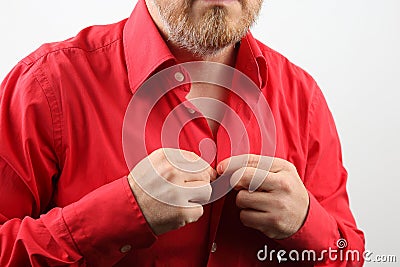 Man fastens buttons on his shirt Stock Photo