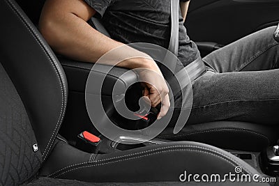 man fastens his seat belt. Road safety. Injury Prevention Stock Photo