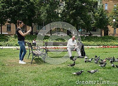 Man Is Feeding Pigeons Editorial Stock Photo