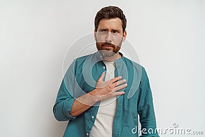 Man feeling sick and nauseous while standing on white background Stock Photo