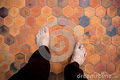 Man feet standing on the clay tiles Stock Photo
