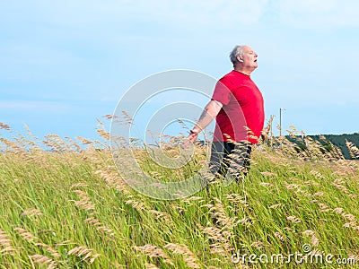 Man in field with breeze Stock Photo