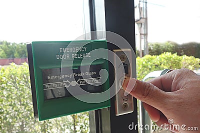 Man figure press the bottom the emergency door release. Stock Photo