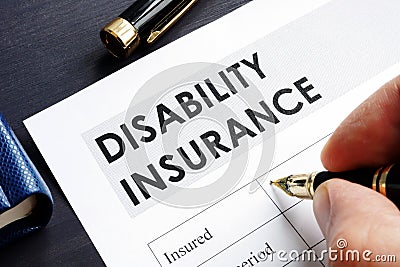 Man is filling in Disability insurance. Stock Photo