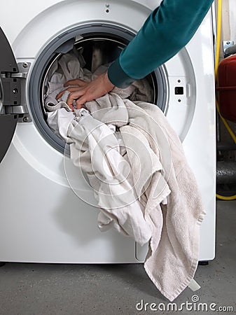 Man filling laundry in the washing machine Stock Photo