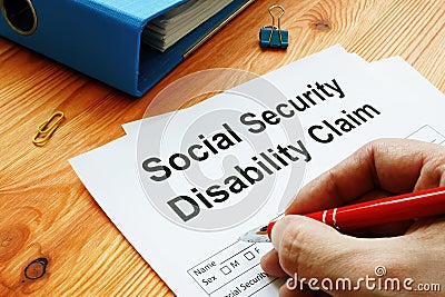 Man filling in Social Security Disability Claim Stock Photo