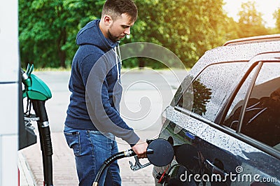 Man is filling tank of his car on the gas station Stock Photo