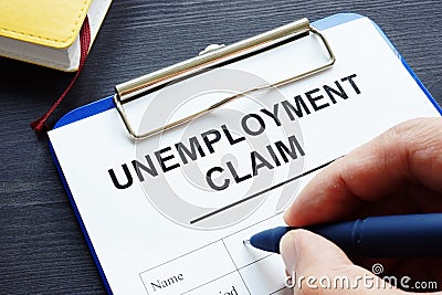 Man is filling in Unemployment claim form. Stock Photo