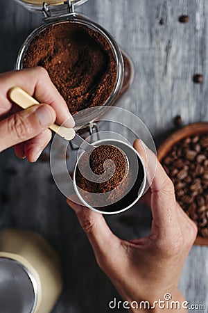 Man fills with coffee the funnel of a moka pot Stock Photo