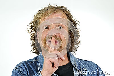 Man with finger on lips Stock Photo