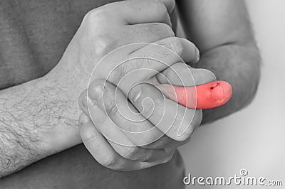 Man with finger pain is holding his aching finger Stock Photo