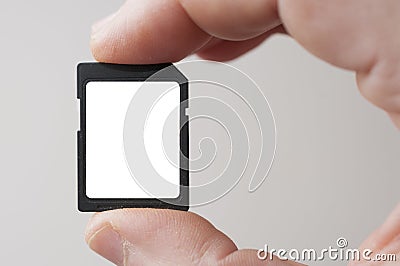 Man fingers hold a blank label SD standard definition memory card Stock Photo