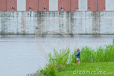 Man Fishing in the London Avenue Canal Editorial Stock Photo