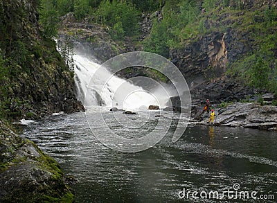 Man fishing near waterfall Stock Photo