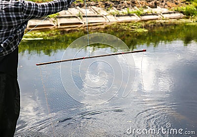 Man with a fishing net in hands. Illegal poacher Stock Photo