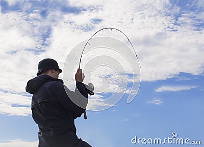 Man fishing pulling hard at rod. Stock Photo