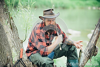 Man fishing relaxing while enjoying hobby. Male hobby. Home of hobbies. Fly fishing adventures. Cheerful mature Stock Photo