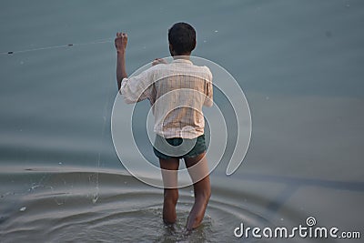 Man fishing by his river Editorial Stock Photo