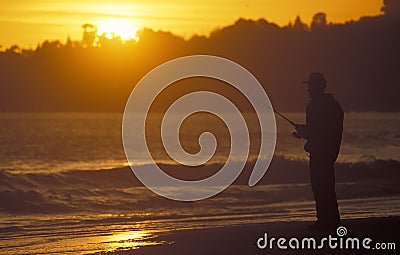Man fishing in the sea at sunset Editorial Stock Photo