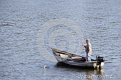 Man fishing from a small boat Editorial Stock Photo