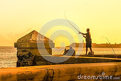 Man fishing during a sunset in Havana Editorial Stock Photo