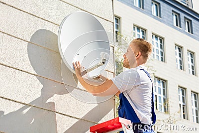 Man Fitting TV Satellite Dish Stock Photo