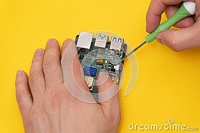 Man fixes microcomputer with screwdriver Stock Photo