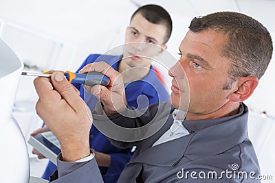 Man fixing electronic circuits in service center Stock Photo