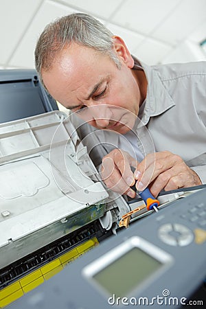Man fixing electronic circuits in service center Stock Photo