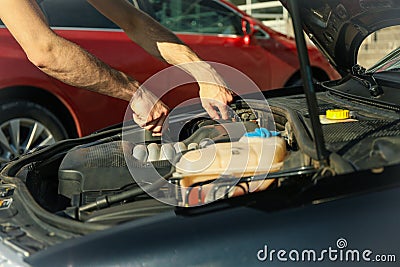 Man fixing engine Car inspection. Work of mechanic Stock Photo