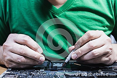 Man fixing laptop computer Stock Photo