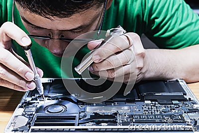 Man fixing laptop computer Stock Photo