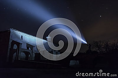 Man with Flashlight at Ruins Stock Photo