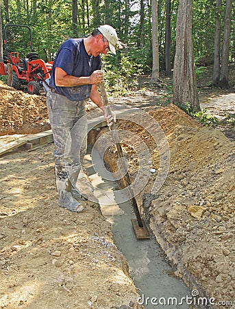 Man floating concrete footer Stock Photo