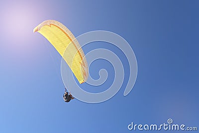 Man flying on a paraglider on the blue sky background Stock Photo