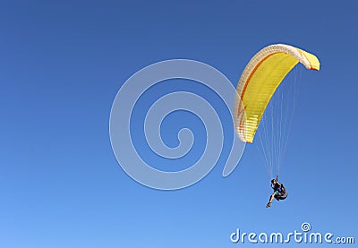 Man flying on a paraglider on the blue sky background Stock Photo