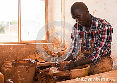 Man focused on work on pottery wheel Stock Photo