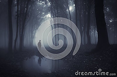 Man in a forest with pond and fog after rain Stock Photo