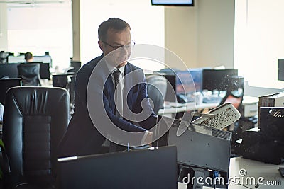 A man freaks out and gets depressed from a mistake and breaks the keyboard on the monitor. The male manager is angry and Stock Photo